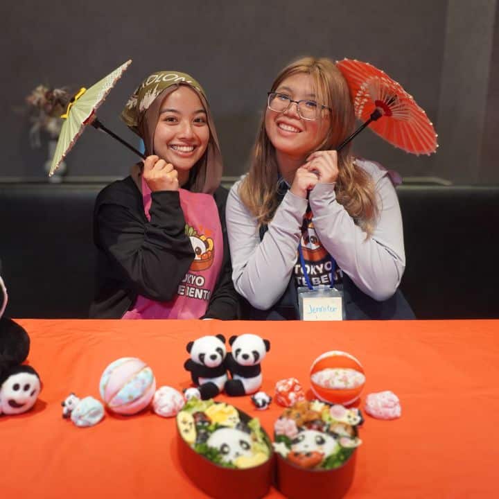 Smiling guests holding their finished character bento
