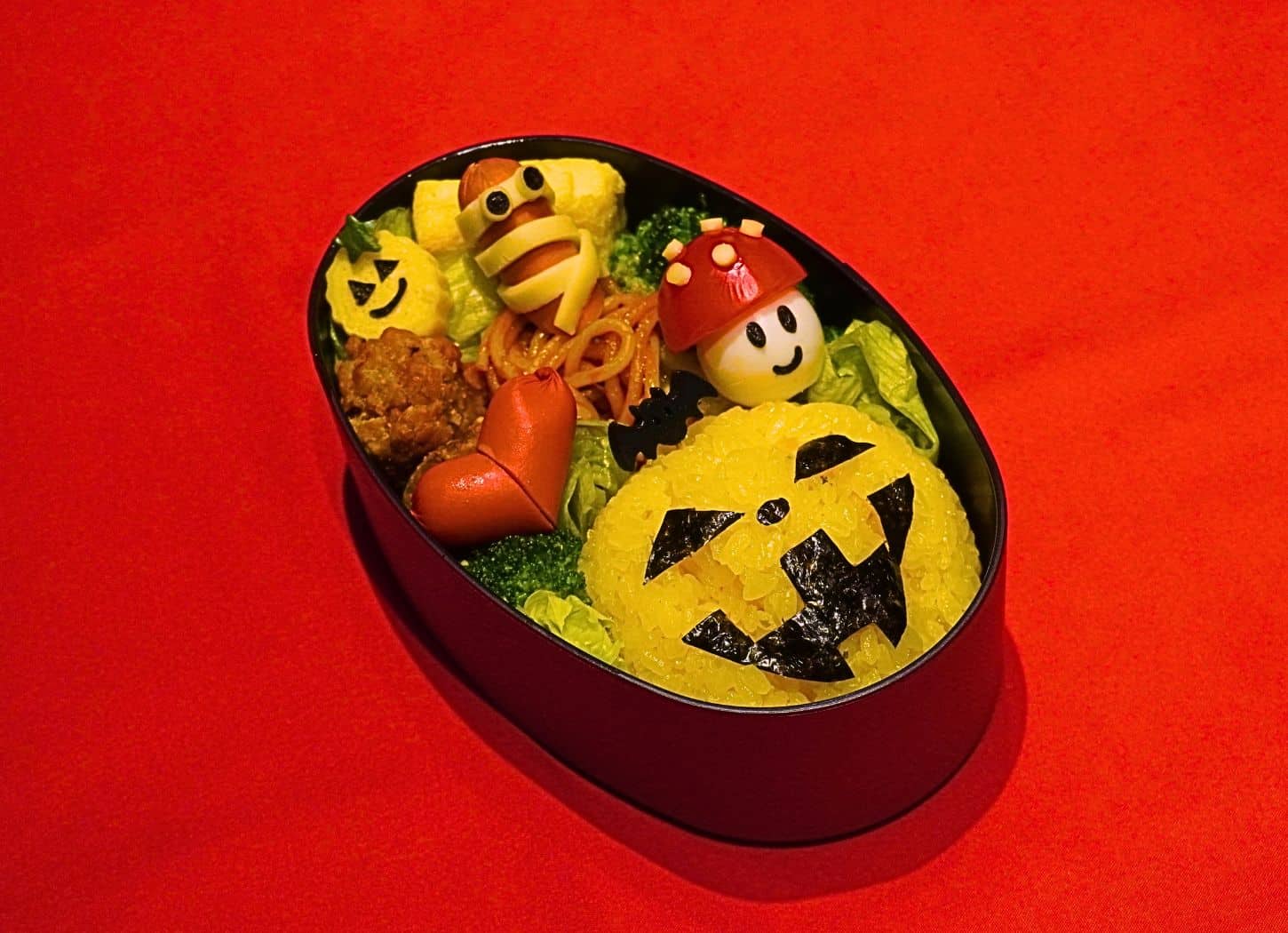 Halloween seasonal special character bento design with a jack-o-lantern rice ball